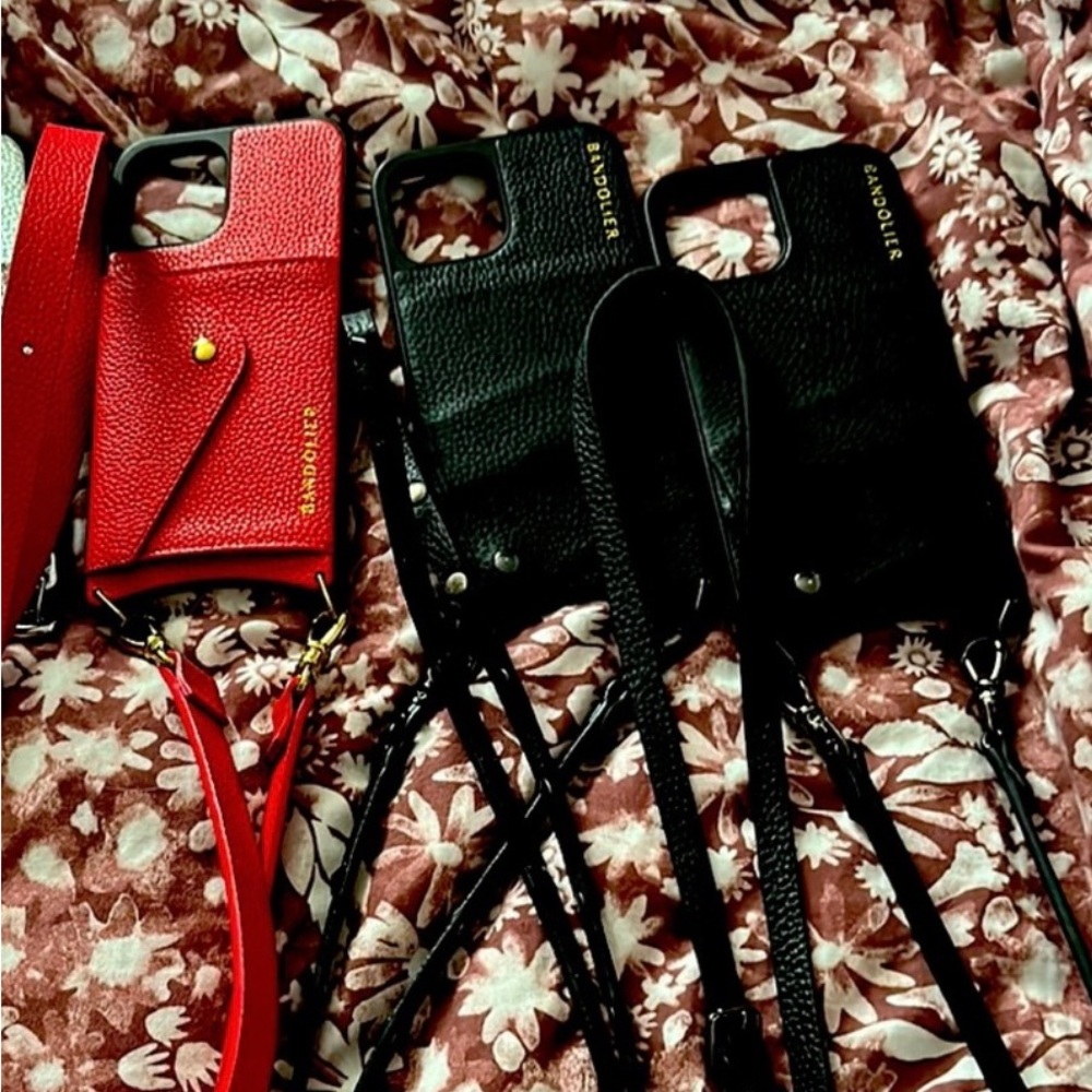 3 Bandoliers iPhone 12 Pro Max cases. A red, a silver and two black.